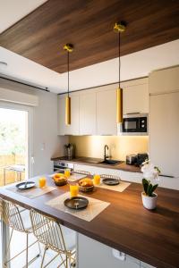 a kitchen with a table with food on it at L'Escapade Indigo - Balnéo - Sauna in Tournefeuille