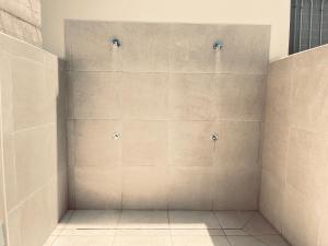 a shower with four shower heads on a wall at Poseidon en Playa Arena in Puerto de Santiago