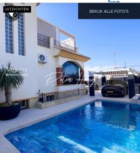 a villa with a swimming pool in front of a building at Quickcasaspain sl in Rojales