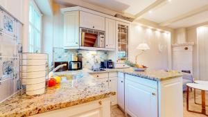 a kitchen with white cabinets and a counter top at Uep Soel in Kampen
