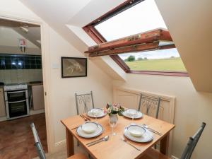 a dining room with a table and a skylight at Uplands in Compton