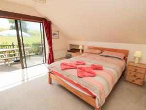 a bedroom with a bed with red towels on it at Uplands in Compton