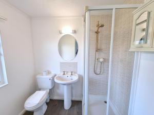 a white bathroom with a toilet and a sink at Birch 25 in Garton +10 photos
