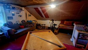 a living room with a ping pong table at Puķkalniñš in Ventspils