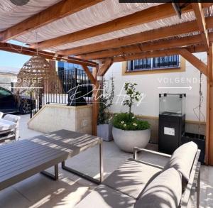 a patio with a wooden pergola and a bench at Quickcasaspain sl in Rojales