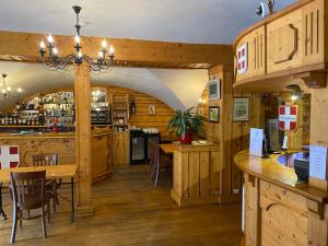 a kitchen and dining room with a table and chairs at Auberge de Savoie in Moutiers