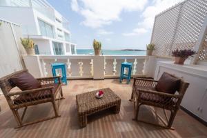 a balcony with chairs and a table and the ocean at Nos Kasa in Sal Rei