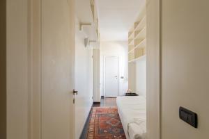 a room with a bed and a hallway with a door at Celeste Retreat al Pantheon - Homkeey Apartments in Rome