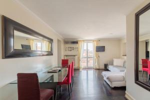 a living room with a desk and red chairs at Celeste Retreat al Pantheon - Homkeey Apartments in Rome