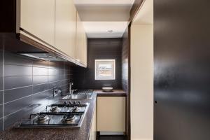 a kitchen with a stove and a counter top at Celeste Retreat al Pantheon - Homkeey Apartments in Rome