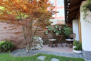 a small garden with two chairs and a table at Apartment Mario in Ptuj