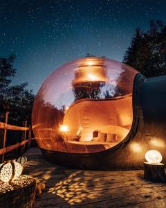 a large glass sphere sitting on a table at night at Maso La Marianna Bubble Glamping in Trentino in Sant'Orsola Terme