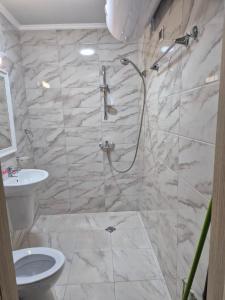 a bathroom with a shower and a toilet and a sink at Marea Garden, Ravda - Studio with Pool by Flat Mаnager in Ravda