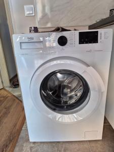 a white washing machine sitting in a room at Marea Garden, Ravda - Studio with Pool by Flat Mаnager in Ravda