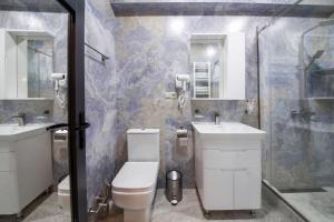 a bathroom with a toilet and a sink and a shower at Kera Ethno Hotel in Gvishtibi