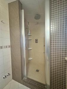 a shower with a glass door in a bathroom at Casa MiLo in Foggia +5 photos