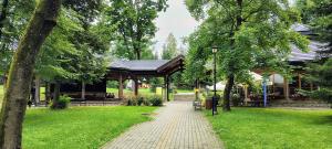 a gazebo in a park with a brick path at Rabka Serenity in Rabka-Zdrój