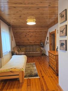 a bedroom with a bed and a wooden ceiling at Ogrodowa 14 in Podgórzyn