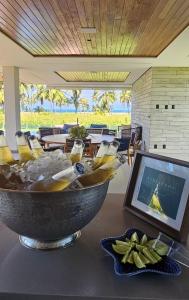 a large bowl on a table in a restaurant at Nossa Casa | Frente Mar, 5 Suítes Exclusivas in Praia do Forte