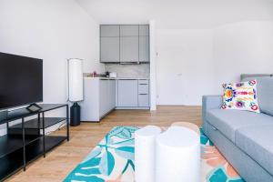 a living room with a couch and a kitchen at Central Studio sleeps 4 in Luxembourg