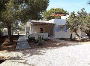 a white house with trees in front of it at Villa Love, ET4013 in Es Pujols