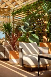 a lobby with plants and a couch and a table at Radisson Blu Resort & Spa in Split