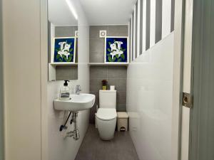a small bathroom with a toilet and a sink at 3 Double Beds - Great Area, Perfect for Families in Seville