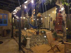 a room with a hammock and some plants and lights at 21 Cozy Home in the Heart of the City in Stockton +74 photos