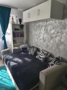a bedroom with a bed with pillows on it at Home MARIA in Orşova