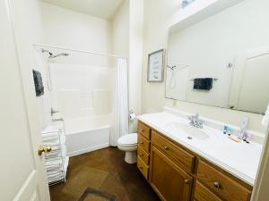 a bathroom with a sink and a toilet and a mirror at Chateau 6 in Hammond +41 photos