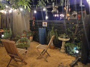a patio with two chairs and a table and plants at 21 Cozy Home in the Heart of the City in Stockton