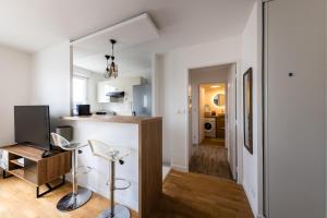 a kitchen and living room with a counter and a desk at Chic&Cosy 1-Bedroom Apart,2 min Metro,10 min Paris in Villejuif