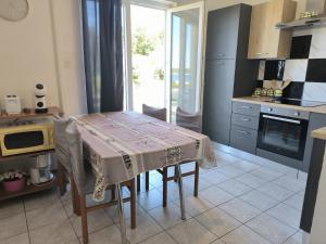 a kitchen with a table with a table cloth on it at Apartments Opsenica Barbat in Barbat na Rabu