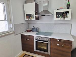 a kitchen with a sink and a stove top oven at Ferienwohnung Würzberg - Odenwald in Michelstadt +4 photos