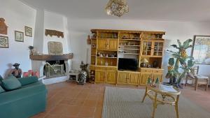 a living room with a couch and a fireplace at Casa da Mãe in A dos Cunhados