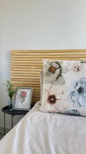 a bed with a pillow and a table with a side table at Modern Ocean-View Apartment in Durban +8 photos