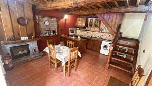 an overhead view of a kitchen with a table and fireplace at Los Janos de Argovejo in Argovejo