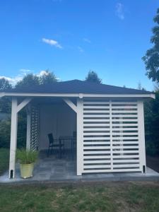 a pavilion with a table on a patio at Spanko in Sztutowo