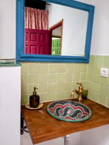 a bathroom counter with a sink and a mirror at La Maestra in Trevélez