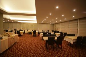a large room with tables and chairs in it at Hotel Guven in Sanlıurfa
