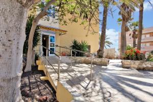 a staircase leading to a building with palm trees at Chasna in Arona