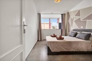 a bedroom with a bed with two teddy bears on it at Chasna in Arona +21 photos