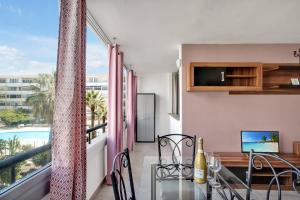 a dining room with a balcony with a view of a pool at Chasna in Arona