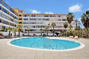 a swimming pool in front of a large building at Chasna in Arona