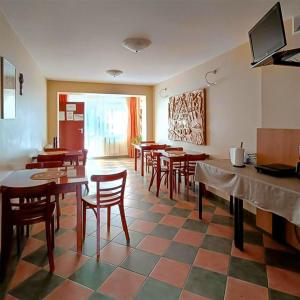 a restaurant with wooden tables and chairs in a room at Ośrodek Wypoczynkowy "Przy Lesie" in Karpacz