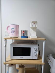 a table with a microwave and a blender on it at SNU Station 13min, Line 2, Hongdae,Gangnam 30min, 6pax in Seoul