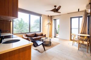 a kitchen and living room with a couch and a table at Serenity Terraces Beach, Resort in Kokrobite
