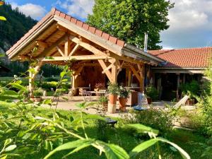 a wooden house with a roof at L'arbre à chapeaux in La GrandʼCombe-Châteleu
