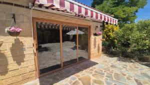 a patio outside of a house with sliding glass doors at Entre Viñedos in Fuentenebro