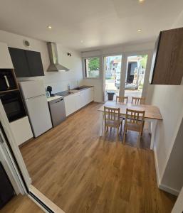 a kitchen and dining room with a table and chairs at Gites des ammonites 2 in Montalieu-Vercieu